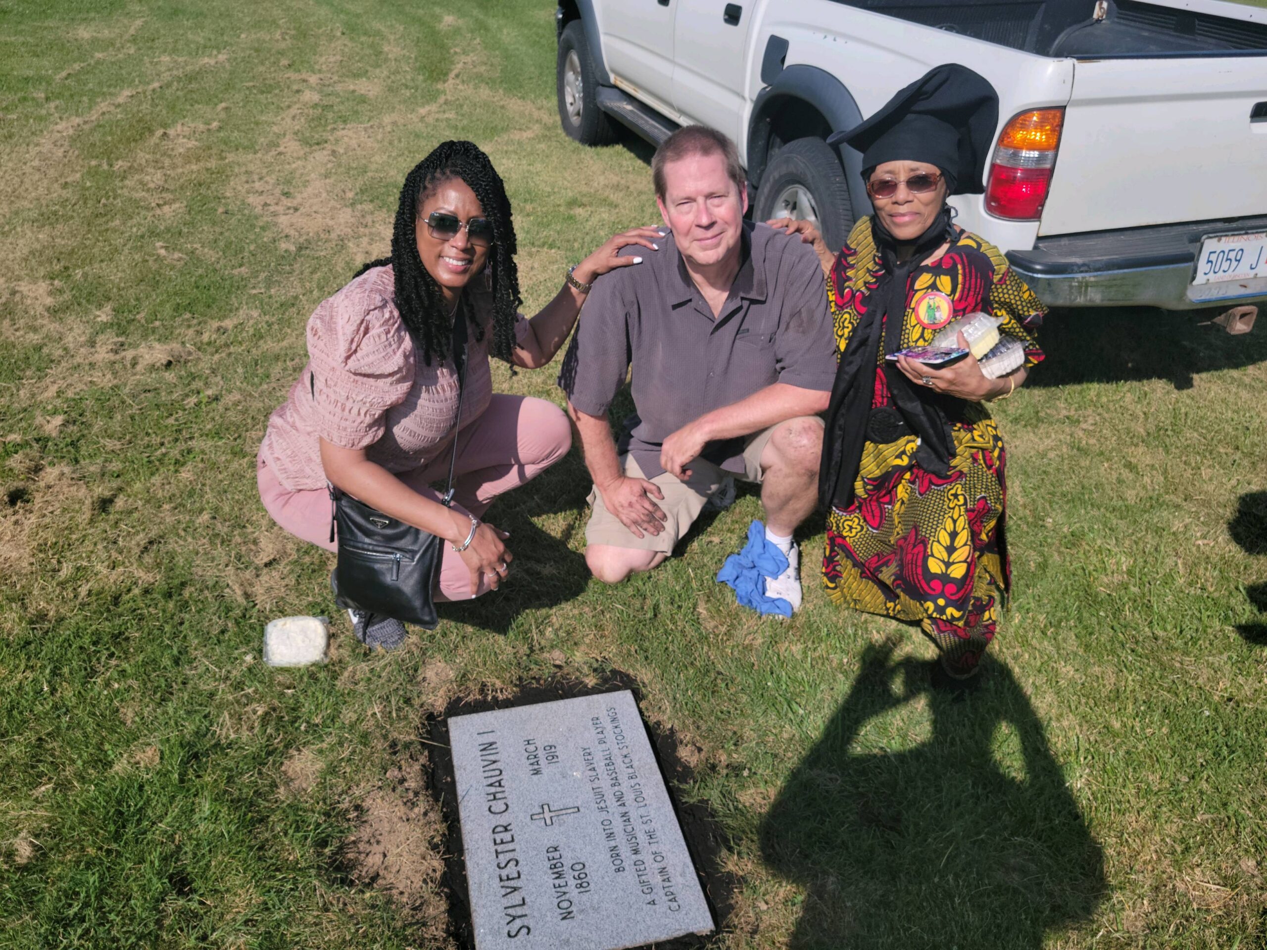 Group Of Individuals Near A Grave